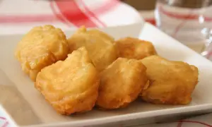 Bocados dorados y crujientes, ¿qué es la pavía pescado? Deliciosos trozos de pescado rebozado en una bandeja blanca.