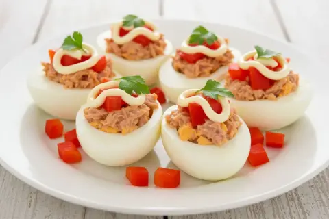 Deliciosos huevos rellenos con atún, tomate y mayonesa, perfectos para tu próxima receta.