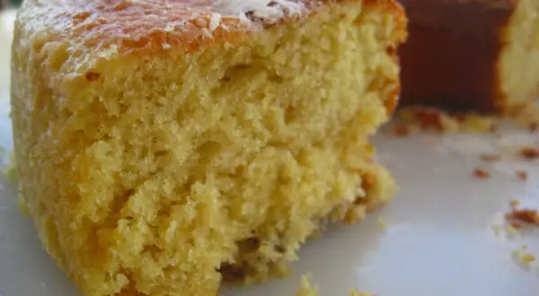 Un trozo de pa de pessic, esponjoso y dorado, con migas esparcidas.